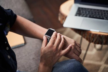 Kadın kişi saati modern cihazla kontrol ediyor