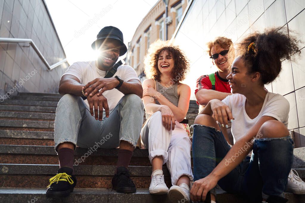 Jolly young people communicating in city centre