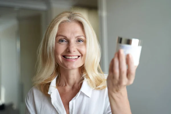 Mujer bonita feliz está mostrando cosméticos profesionales — Foto de Stock