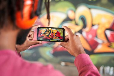 Adam bitirdiği grafitiyi çekiyor.