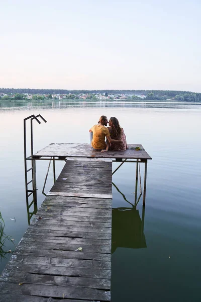 Pareja descansando juntos en el puente de madera — Foto de Stock