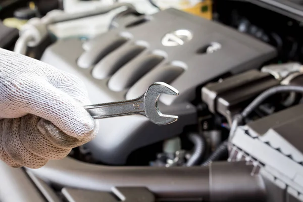 Hand Holding Wrench Blur Car Engine Background — Stock Photo, Image