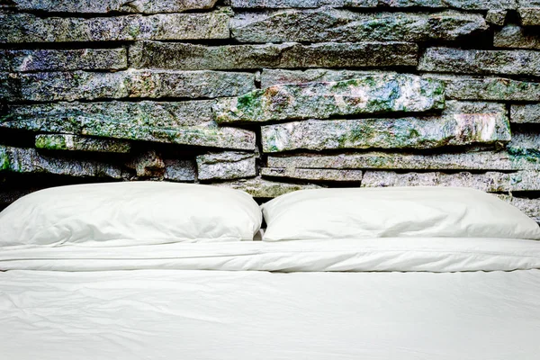 White pillows on a bed and bedding sheets