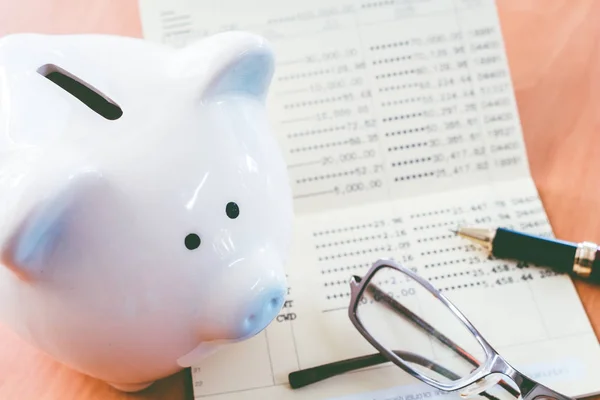 Piggy bank and calculator on business documents background