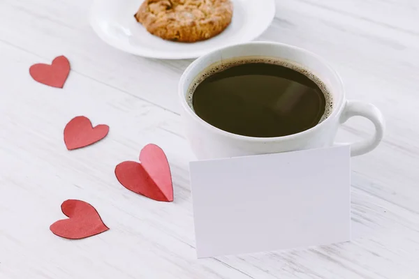 Heart and coffee on a wooden background