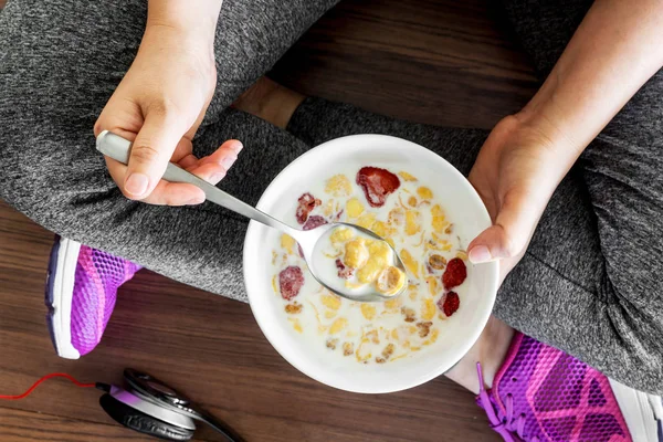 Fitness woman with healthy food on floor