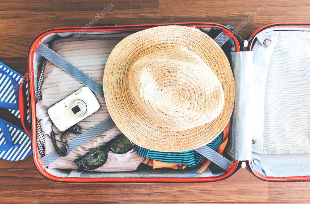Open traveler's bag with woman clothing 