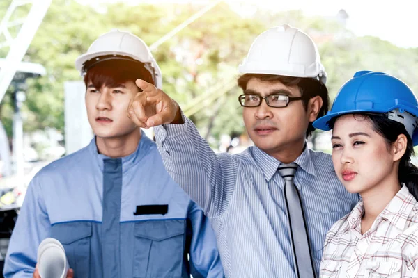 Engineers man and woman construction team on work site