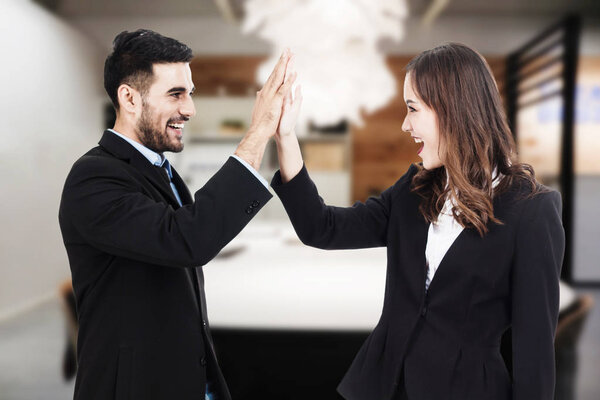 Business people team clapping their hands in office blurred background