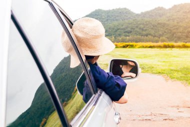 Kadın dağ arka plan ile arabada pencereden rahatlatıcı