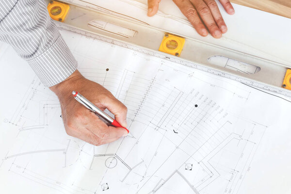 Engineers working with construction tools on table