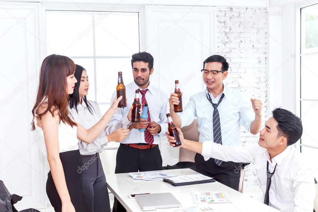 Group of business people professionals successful drink beers in office