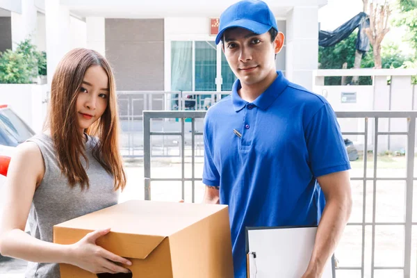 Woman accepting a delivery boxes from delivery man