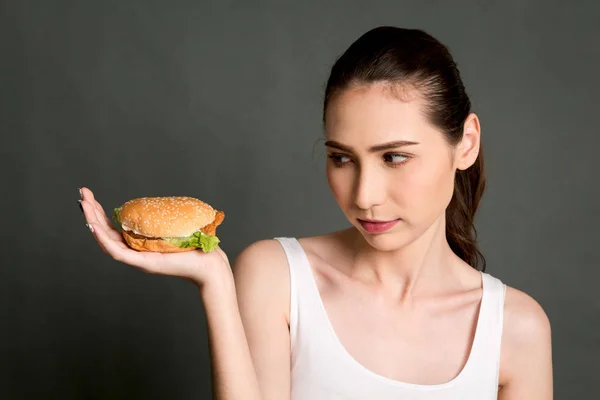 Young Woman Holding Hamburger Gray Background Junk Food Fast Food — Stock Photo, Image