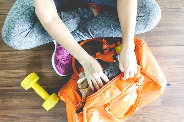 Woman with bag and fitness equipment