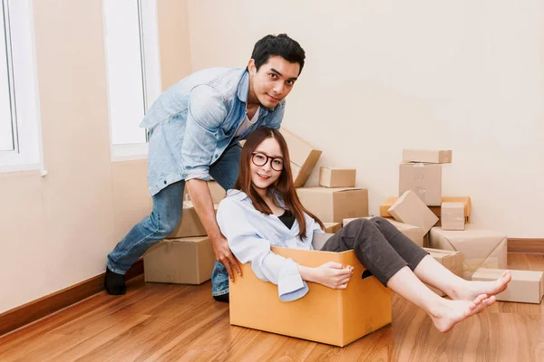 Happy Couple Having Fun Moving Woman Sitting Cardboard Box Home — Stock Photo, Image