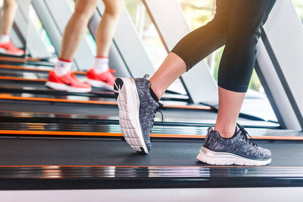 People running on machine treadmill at fitness gym.fitness and lifestyle concept