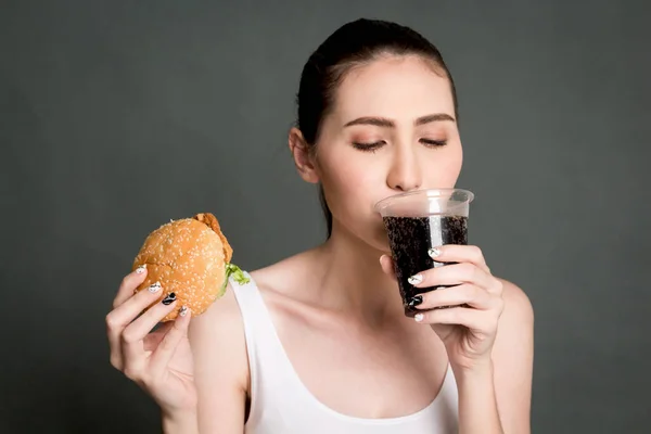 Young Woman Drink Cola Holding Hamburger Gray Background Junk Food — Stock Photo, Image