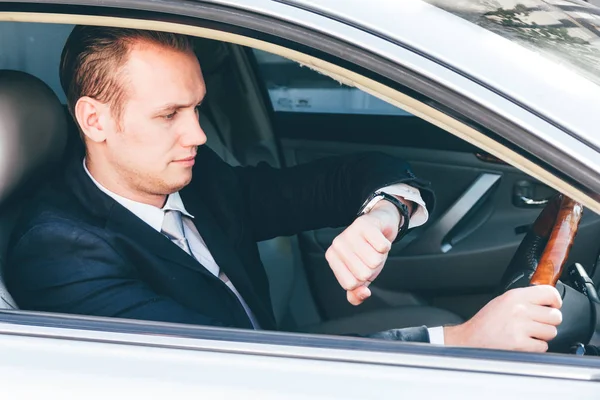 Businessman Looking His Watch While Driving Car — Stock Photo, Image