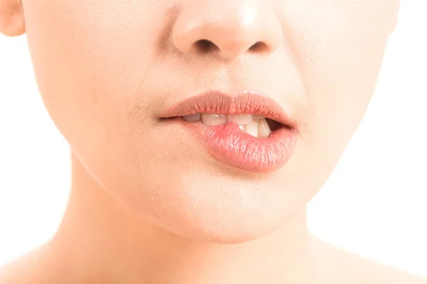 Close-up of female lips mouth biting lip isolated on white background