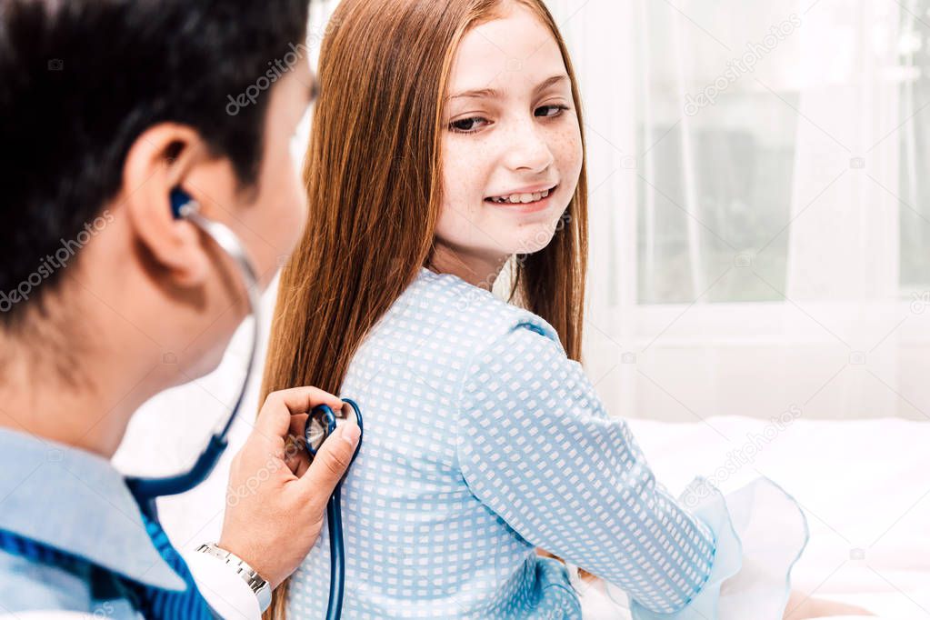 Doctor examining little girl with stethoscope in the hospital.healthcare and medicine
