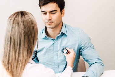 Kadın doktor muayene erkek hasta ile hospital.healthcare ve tıp stetoskop