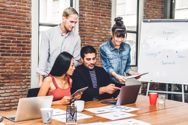 Geçici iş tartışırken grup ve dizüstü computer.creative iş ile çalışma planlama insan ve modern workloft beyin fırtınası. Ekip çalışması kavramı