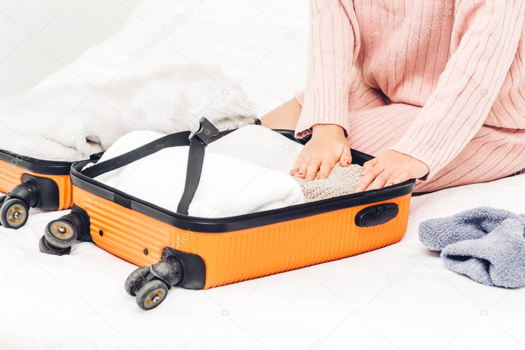 Woman packing a suitcase luggage and backpack for travel at home.Holiday vacation concept