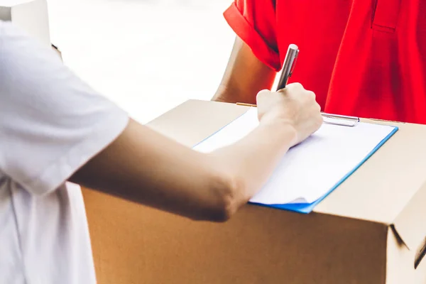 Woman Putting Signature Clipboard Cardboard Box Delivery Man Courier Service — Stock Photo, Image