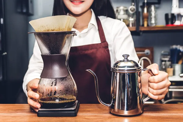 Women Barista making drip coffee in the cafe