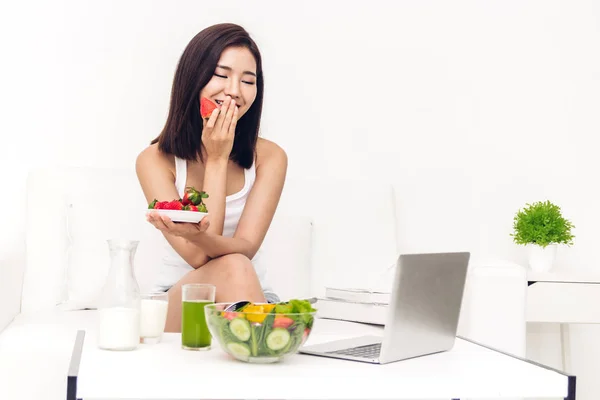 Woman Eating Fresh Strawberry Working Laptop Computer While Relaxing Sofa — Stock Photo, Image