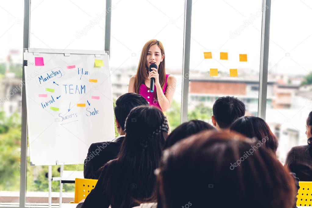 Businesswoman standing in front of group of people in consulting meeting conference seminar at hall or seminar room.presentation and coaching concept