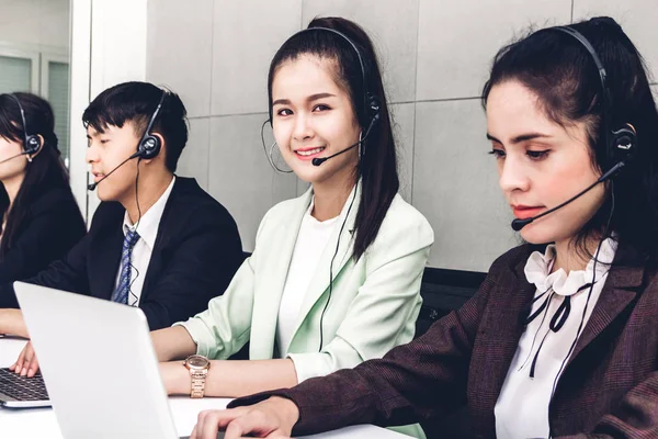 Beautiful businesswoman customer support services working with headset and computer at call center