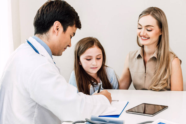 Doctor consulting and check up information with little girl in hospital.A little girl has sick.healthcare and medicine