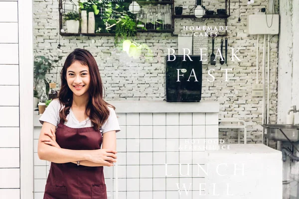 Portrait of woman small business owner smiling and standing with crossed arms outside the cafe or coffee shop.woman barista standing at cafe