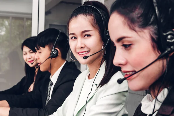 Beautiful businesswoman customer support services working with headset and computer at call center