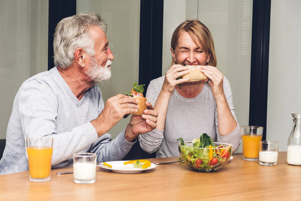 Senior couple enjoy eating  healthy breakfast together in the ki Stock Picture