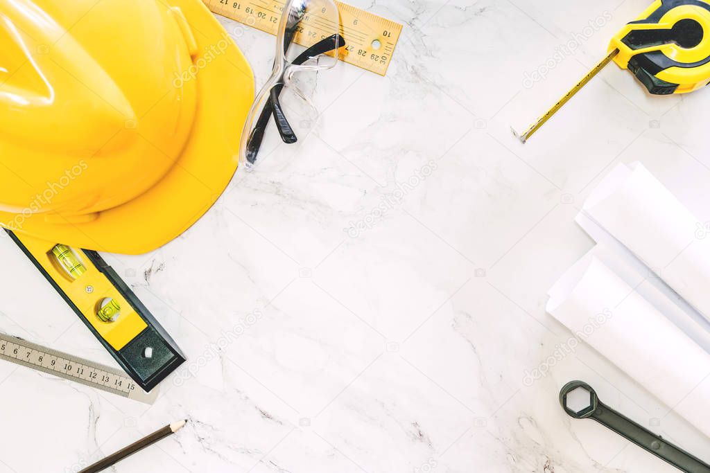 Construction tools with helmet safety on white marble background