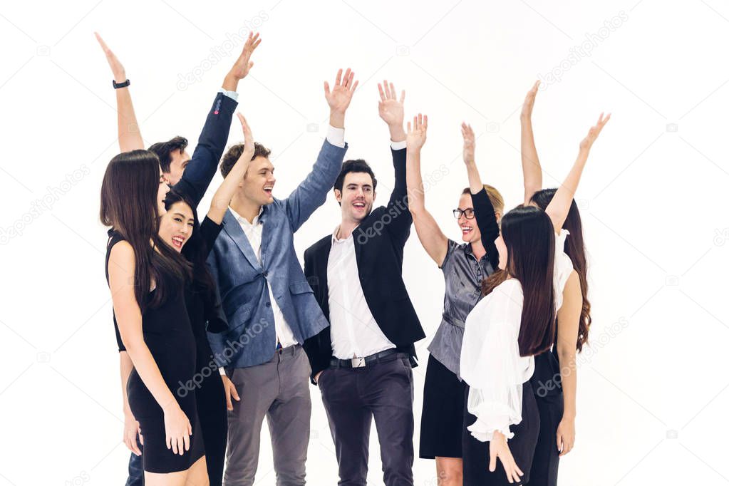 Successful of group of casual business celebrating with arms up 