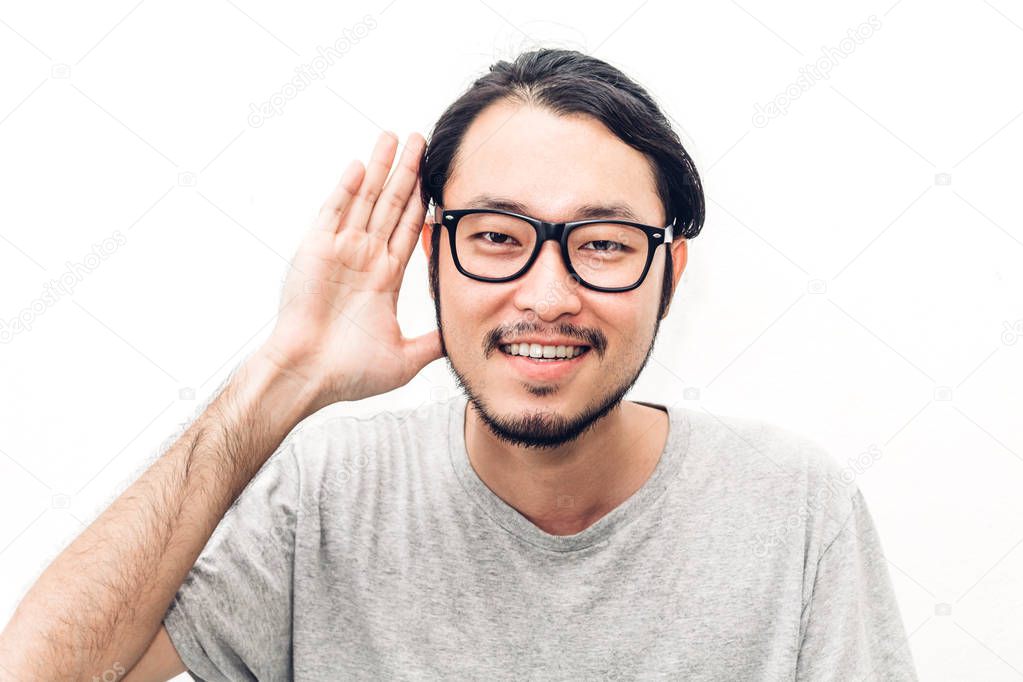 Portrait of happy smiling asian young handsome man overhearing r