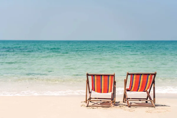 Två stolar på stranden nära havet. Sommar och semesterkoncept BAC — Stockfoto