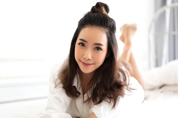 Portrait of asia woman enjoy and relax on the bed in bedroom at — Stock Photo, Image