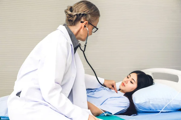 Doctor discussing and consulting with female patient on doctors