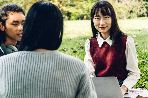 Group of smiling international students or teenagers sitting and — Stock Photo, Image