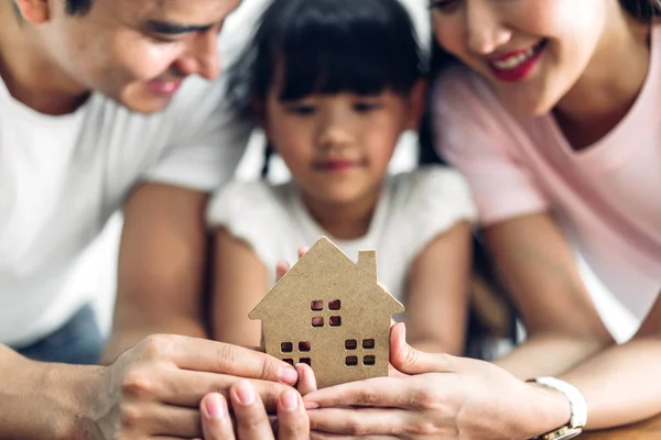 Happy family holding  house in hands.real estate concept — Stock Photo, Image