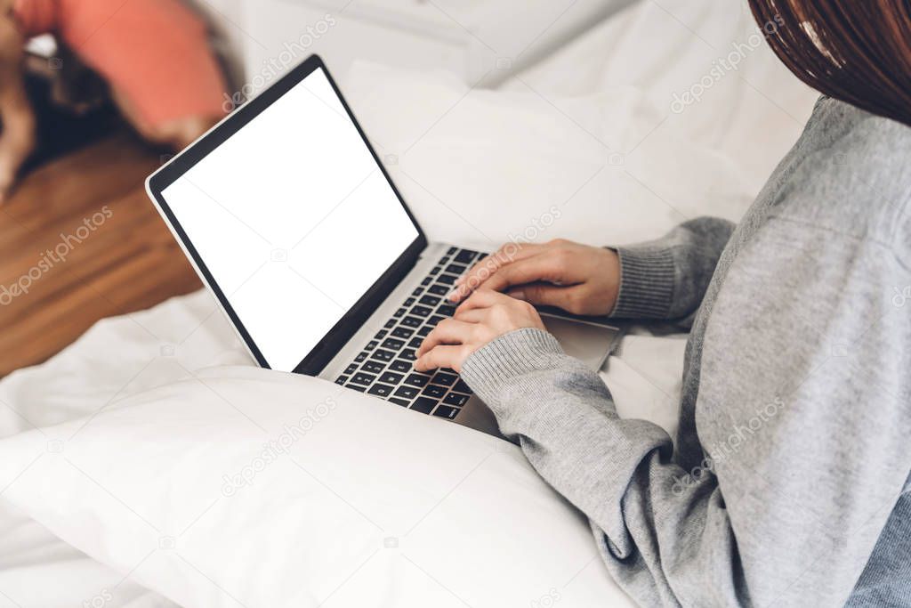 Young woman relaxing using laptop computer in the bedroom.woman 