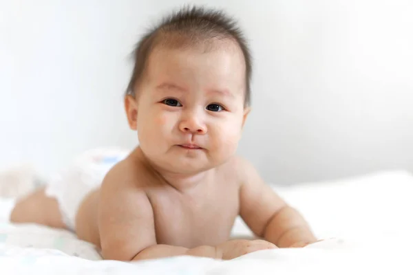 Portrait of happy smile baby relaxing on the bed — Stock Photo, Image