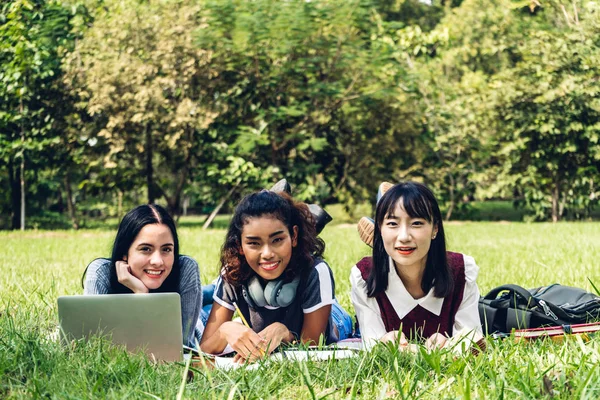 Group of smiling international students or teenagers using lapto — Stock Photo, Image