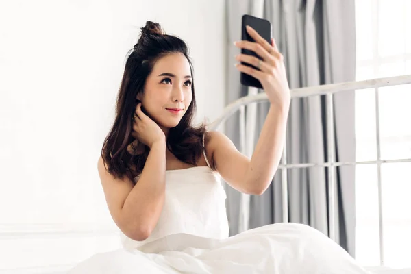 Happy asia woman relaxing using and talking by smartphone on the — Stock Photo, Image