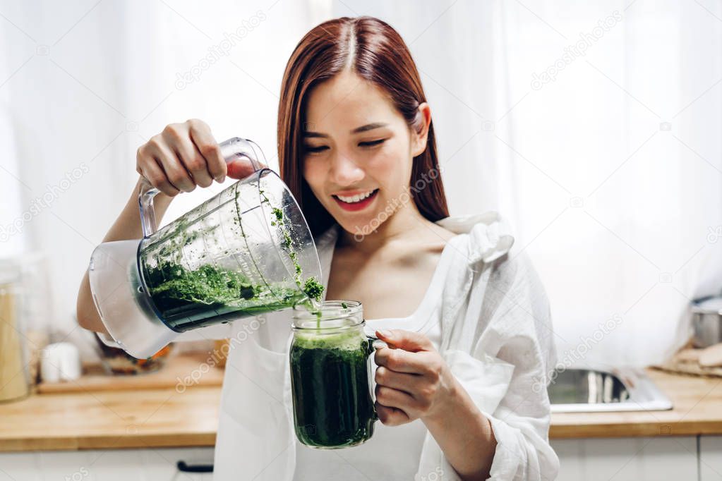 Healthy woman enjoy making green vegetables detox cleanse and gr